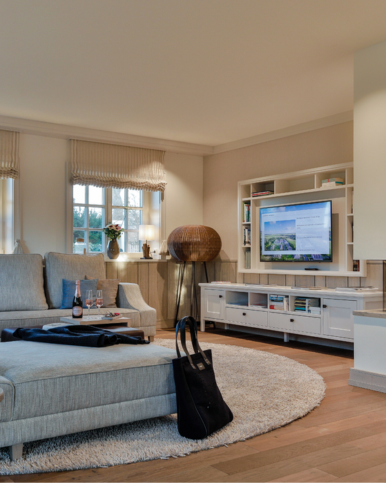 Villa Severin*s Plus living area with fire place, TV & couch hotel Sylt