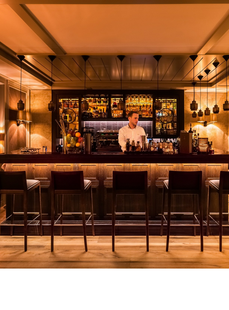 Bar and counter with bartender at the Hotel Severin * s on Sylt