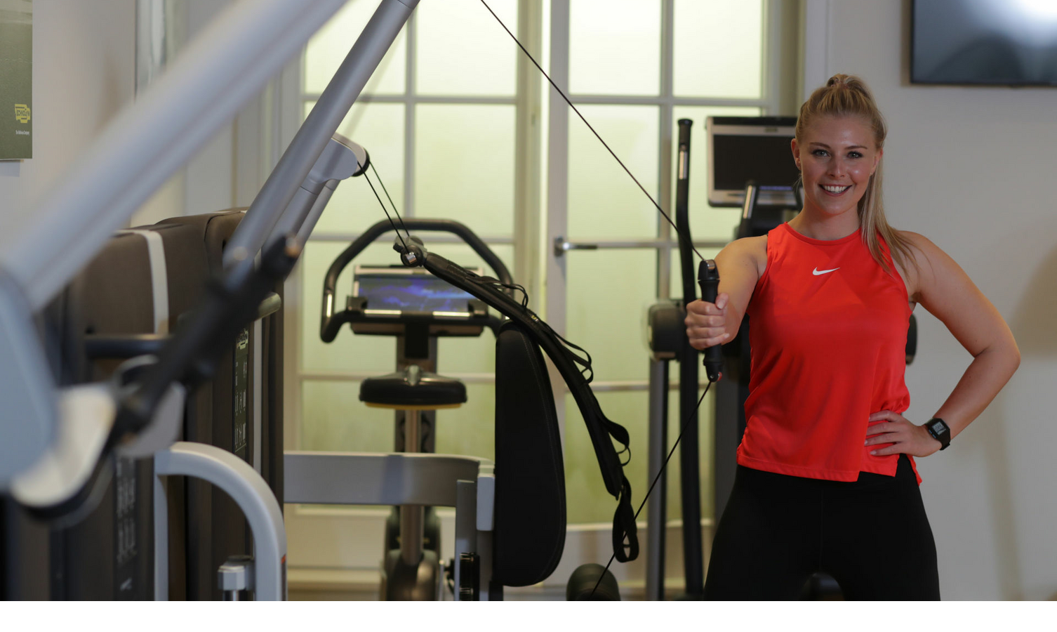 Woman working out on the machine in the fitness room