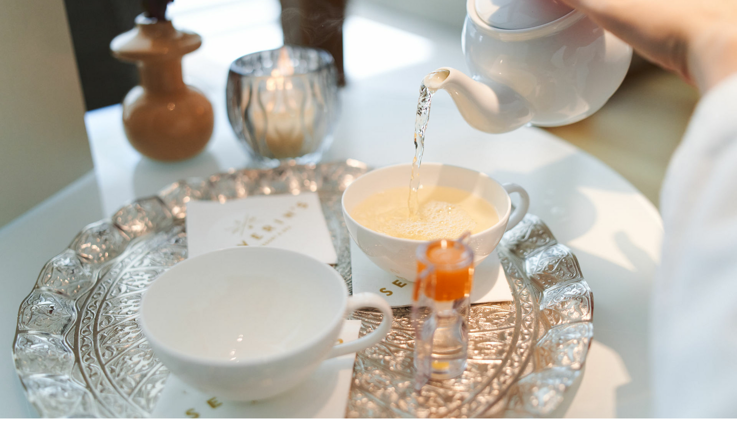 Tea is poured into a cup on an ornate tray at Severin*s Resort & Spa, Sylt.