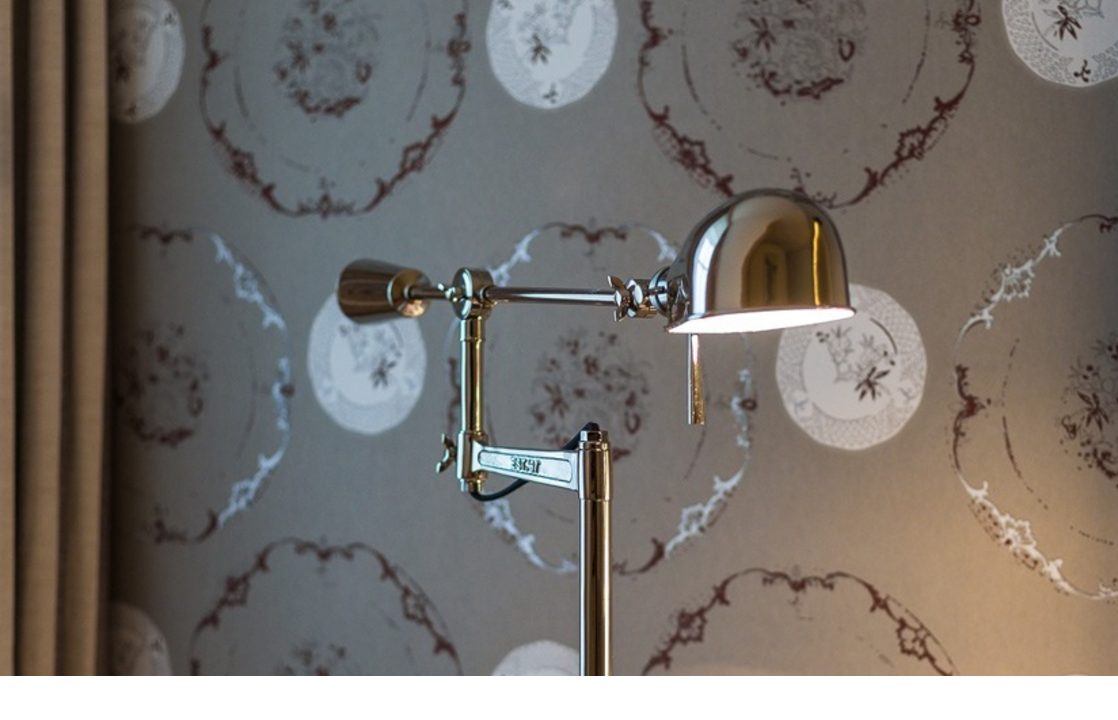 Floor lamp in front of patterned wallpaper at Severin*s Resort & Spa on Sylt, stylishly and elegantly illuminated.