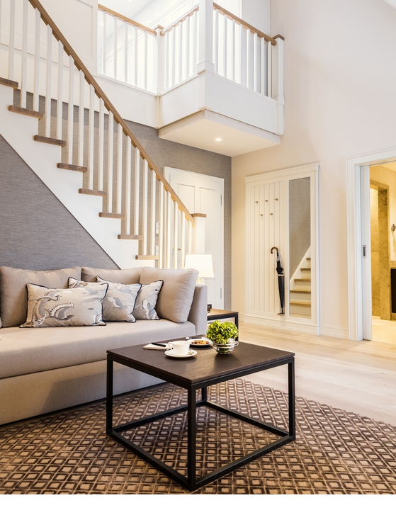 Elegant living room at Severin*s Resort with beige couch, coffee table, staircase and stylish decoration.