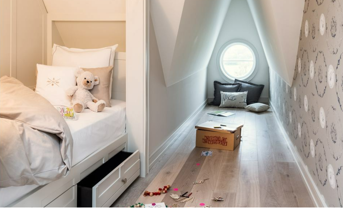 Bright children's room with single bed, cuddly toy, toys on the floor and round window at Severin*s Resort & Spa.