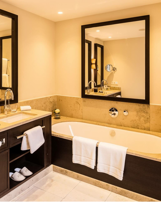 Elegantes Badezimmer im Severin*s Resort & Spa mit Doppelwaschtisch, großer Badewanne und stilvollem Dekor.