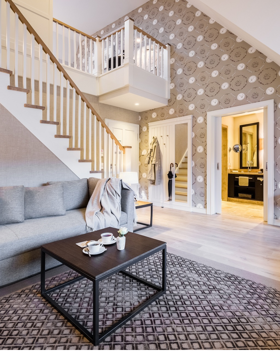 Luxurious living room at Severin*s Resort with elegant staircase, cozy sofa and modern decor.