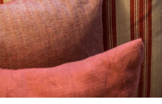 Red and beige striped cushions at Severin*s Resort & Spa on Sylt, stylishly and comfortably arranged.