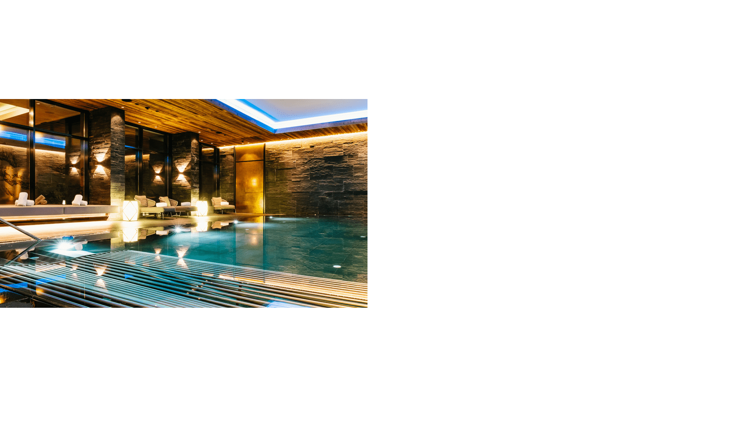 Luxuriöser Innenpool mit stilvoller Beleuchtung und eleganten Liegen im Severin*s Resort & Spa auf Sylt.